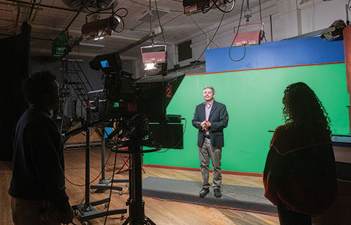 Top: Adrian Velarde, KRWG Public Media general manager, speaks in front of a camera crew in KRWG’s studio on NMSU’s Las Cruces campus. Velarde and six other KRWG staff members are participating in the nine-month Digital Transformation Program. A key part of the program provides intensive data analytics training to enhance data literacy among station leaders like Velarde.