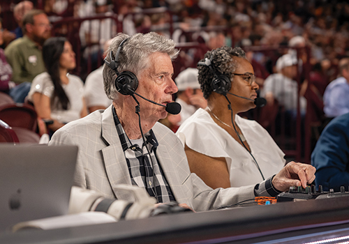Jack Nixon, left, broadcasts one of his final Aggie men’s basketball games at the Pan American Center alongside Anita Skipper in February 2025.