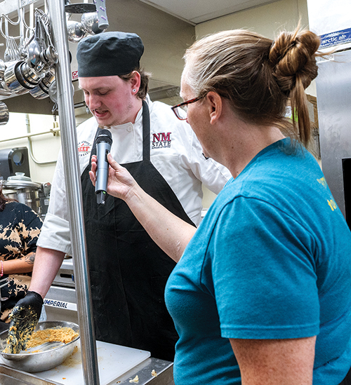 Chef and HRTM instructor Danielle Young, bottom right, talks with Brogan Hoose. Young created the bracket-style culinary competition in 2024 to reinvigorate the local restaurant industry while giving students opportunities to interact with professionals.