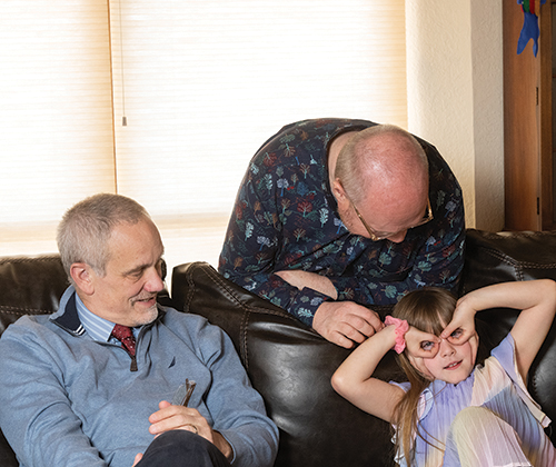 Serenity goofs around with her grandfathers.