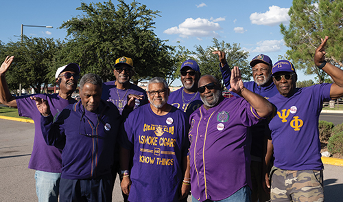 Members of Omega Psi Phi attend an Aggie football tailgate. 