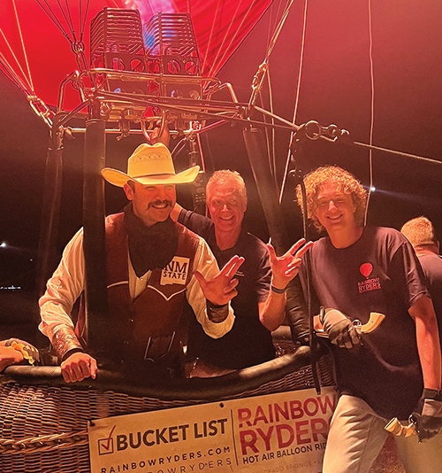  Brad Rice, a pilot associate with Rainbow Ryders, and his son and crew chief, Carson Rice, welcome Pistol Pete on Aggie Up. 