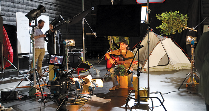  A musician plays guitar on a set built inside the new Creative Media Technology studio, which boasts a 4,000-square-foot soundstage.