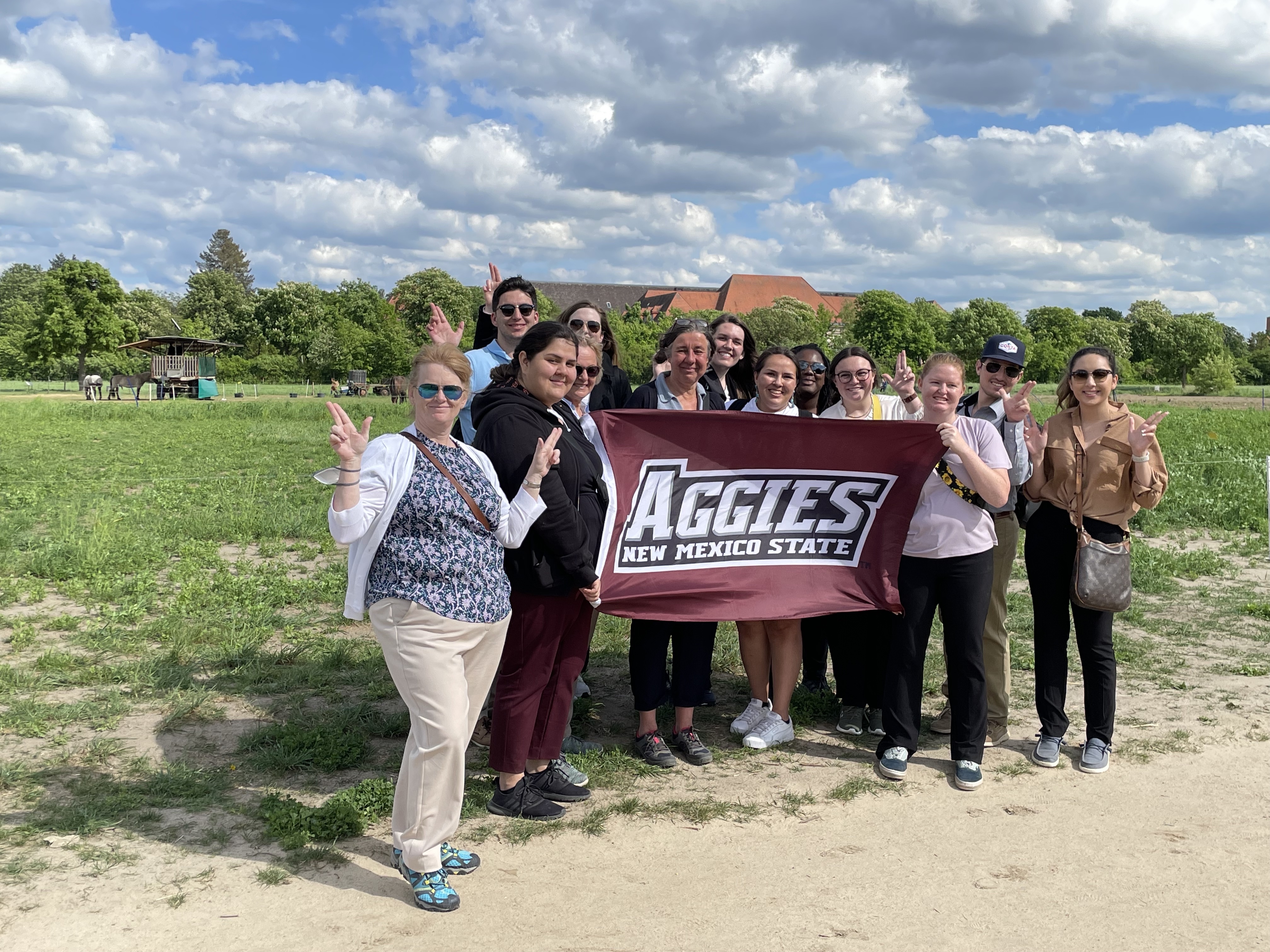 Group of students holding an Aggie banner