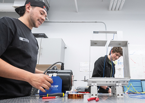 Top: Angel Chafino, left, and Devin Binns work on a project in the Environmental Testing and Structures Laboratory in Jett Hall. 