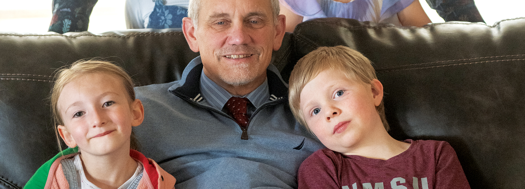 NMSU President Valerio Ferme, seated, embraces grandchildren Autumn, left, and Dante, as Ferme’s husband, Giorgio Corda, poses with twin grandchildren Lucy, left, and Serenity at the University Residence, where the family lives.