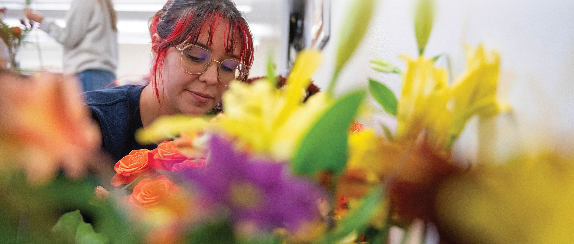 Sabrina Montoya assesses flowers during a floral team work session. NMSU’s floral team earned first-place finishes at both the national and regional competitions in July 2023. 